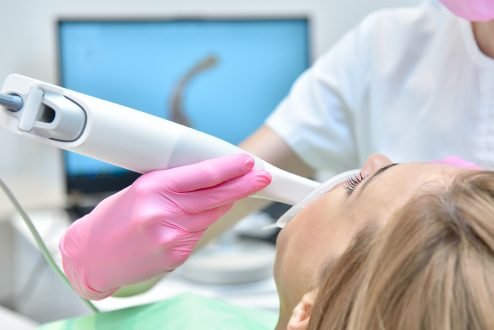 Intraoral camera used to see gums and teeth displaying real time images on a monitor